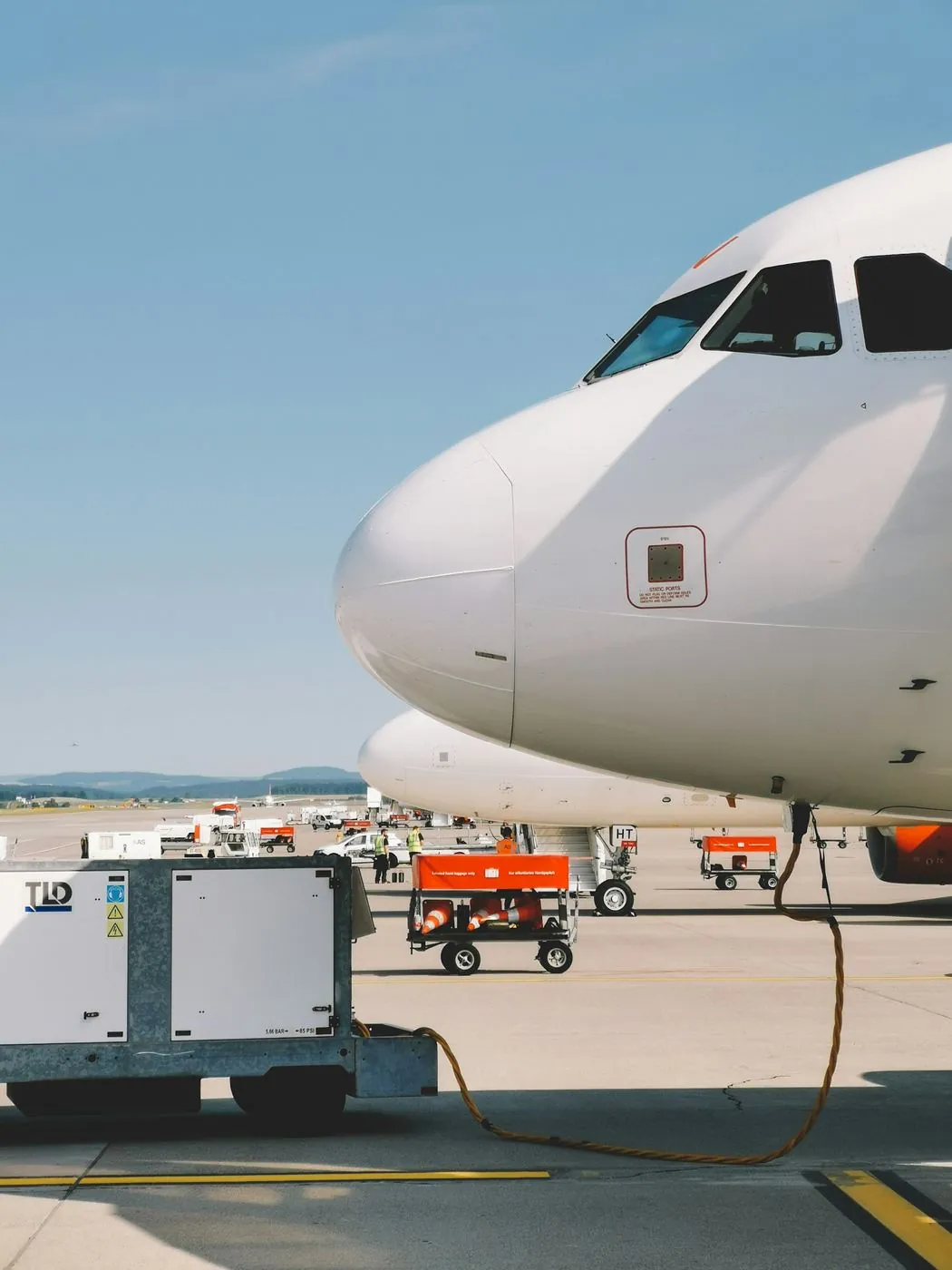 Ground power unit beside an aircraft